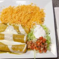 Enchiladas Veracruz · Three enchiladas stuffed with shrimp and scallops, topped with shredded cheese and green tom...