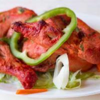 Chicken Tandoori · Chicken marinated in yogurt and freshly ground spices, skewered and barbecued in a clay oven.