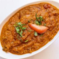 Baingan Bharta · Eggplant roasted in tandoori clay oven, blended with tomatoes, onions, and flavorful spices.