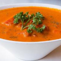 Chicken Makhani (Butter Chicken) · Chunks of chicken breast cooked in clay oven, finished in creamy tomato sauce.
