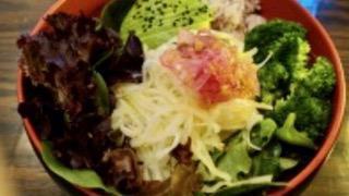 Lemon Pepper Papaya Salad · A Thai inspired green papaya salad on a bed of spring greens and carrots, with red onion rel...