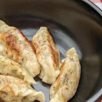 Pork Dumplings (5 Pcs) · Lightly seasoned pan fried dumplings served with a side of soy-vinegar dipping sauce.