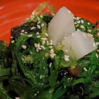 Seaweed Salad · A small side of seaweed salad on a bed of crunchy green papaya, topped with pickled daikon r...