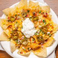 Loaded Nachos · Loaded nachos topped with ground beef, four cheese, pico de gallo, scallions, jalapeños and ...