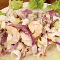 Ceviche Mixto · Sliced of raw white fish, shrimp, calamari and mussels marinated in lemon juice and served w...