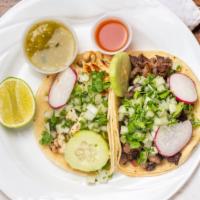 Tacos Mexicanos · One piece. Street style. Double white corn tortilla topped with cilantro and onion, served w...