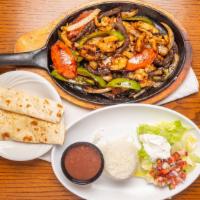 Fajitas · Our sizzling fajitas are served with Mexican rice, black beans, lettuce, pico De gallo, guac...