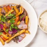 Lomo Saltado / Steak & Fries · Sliced steak sautéed in a tomato and onion sauce with French fries. Served with rice and bea...