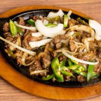 Meaza Tibs House Special · Cubes of beef cooked with pieces of fat, sauteed on a frying pan with onions, jalapenos, and...