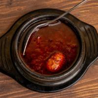 Doro Wot · Chicken leg and boiled egg cooked in a spicy and sweet sauce, with Ethiopian butter, onions,...