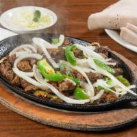 Tibs · Cubes of beef sauteed with onions, tomatoes, jalapenos, garlic, and house sauce.