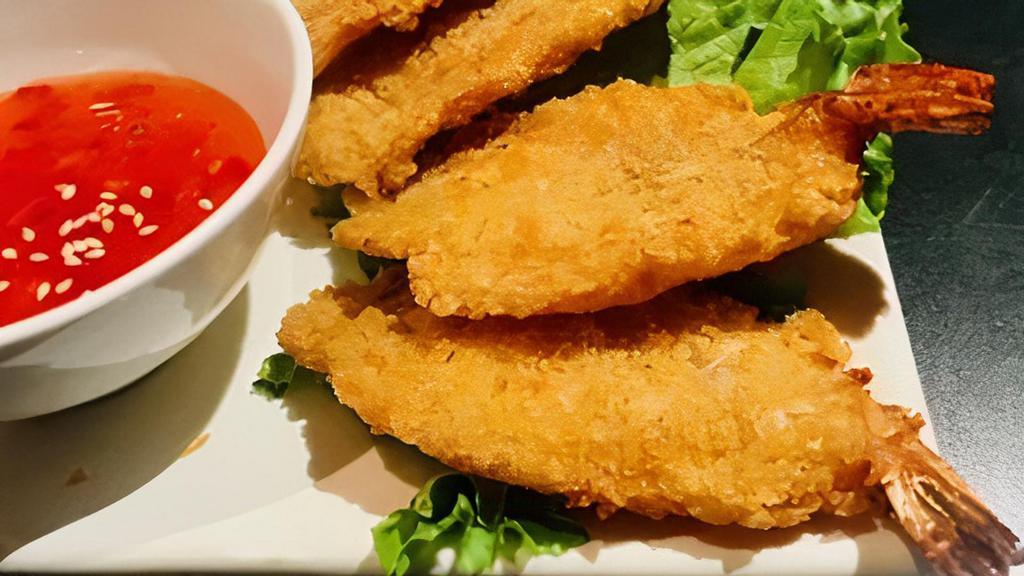 Coconut Prawns · Breaded coconut prawns deep fried and served with house sweet chili sauce. Tom chien dua.