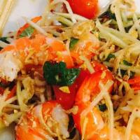 Green Papaya Salad With Shrimp · Shredded green papaya and carrot, diced tomatoes, roasted peanuts tossed with a fish sauce
v...