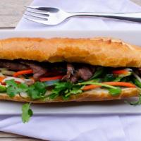 Marinated Grilled Pork Sandwich‎ · Banh mi sandwiches come with diced pickled radish and carrots, cucumber, slices of jalapenos...