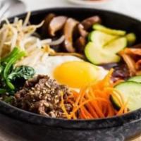 Bulgogi Bibimbap · Served in a bed of rice with assorted veggies, your choice of meat, fried egg and spicy Kore...