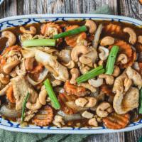 Cashew Nut Chicken · Chicken stir-fried with onions, scallions, carrots and cashew nuts in light brown sauce.