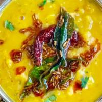 Daal Tadka · Yellow lentil soup tempered with cumin, mustard seeds, garlic, chilies, curry leaves in clar...