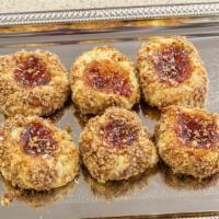 Thumbprints (Each) · Butter cookie rolled in pecans and filled with strawberry jelly.