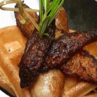 Chicken & Waffles · Our signature jerk chicken sausage paired with a fresh Belgian waffle topped with plantains.
