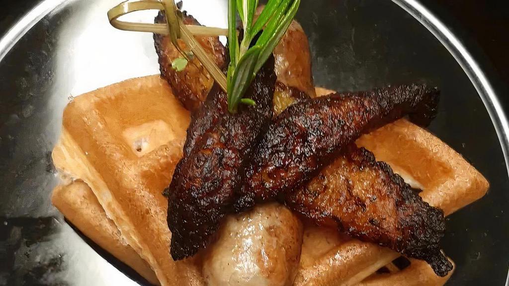 Chicken & Waffles · Our signature jerk chicken sausage paired with a fresh Belgian waffle topped with plantains.
