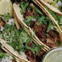 Tacos De Carnitas · 4 Tacos. Served with meat, onion and cilantro. Servido con carne de cerdo, cebolla y cilantro.