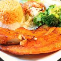 Salmon Cancun · Served with steamed vegetables and white rice.