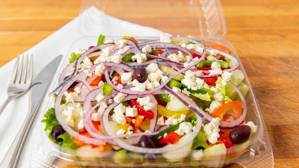 Greek Salad · Feta, kalamata olives, banana peppers, cucumbers, tomatoes, green and red peppers over romaine lettuce with Greek dressing on the side.
