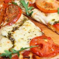 Margherita Pizza · Light sauce, olive oil, fresh garlic, tomatoes, fresh basil, fresh mozzarella and seasonings.