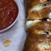 Meat Lover'S Calzone · Made with pepperoni, meatballs, Italian sausage, ham, mozzarella cheese and a side of marina...