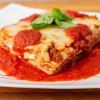 Meat Lasagna · Served with garlic bread.