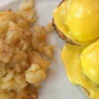 Eggs Benedict · Two poached eggs topped with Canadian bacon and hollandaise sauce over English muffin. Serve...