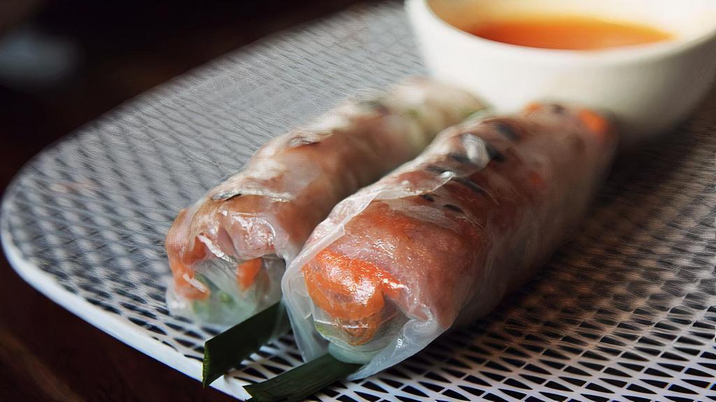 Nem Nướng Cuốn (Grilled Pork Sausage Spring Rolls) · (2) Nem nướng cuốn. Grilled pork sausage spring rolls served with peanut sauce.