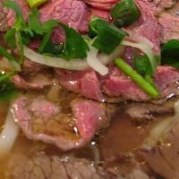 Phở Tái Nạm (Rare Steak And Brisket Phở) · Rice noodles in beef bone broth  w/ sliced rare steak & brisket