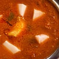Murgh Vindaloo · A very hot chicken curry cooked with red chilies, vinegar, potatoes