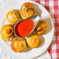Garlic Knots (6 Pieces) · Homemade knots drizzled with garlic butter and served with our tomato sauce.