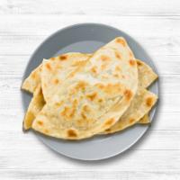 Naan  · House-made pulled and leavened dough baked to perfection in an Indian clay oven.