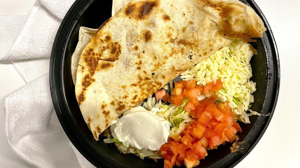 Fajita Quesadilla · Stuffed with Cheddar cheese and your choice of steak or chicken fajita prepared with grilled onions and red and green peppers, garnished with lettuce, tomatoes, onions, sour cream and guacamole.