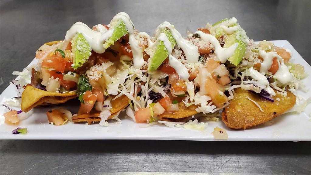 Raja Taquitos · 4 corn tortillas stuffed with roasted poblano peppers, onions and crispy potatoes sautéed in a Parmesan cream sauce topped with pico de gallo. Served with cabbage and cilantro crema.