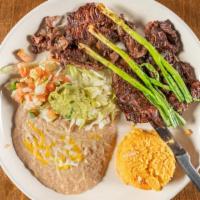Carne Asada · Thin slices of skirt steak charbroiled and garnished with green onions and guacamole. Served...