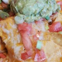 Nachos Fiesta · Crisp Corn Tortilla Chips Topped with Beans, Jalapenos and Melted Cheddar Cheese. Garnished ...