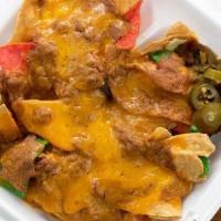 Nachos · Beans and cheese served with sour cream and jalapenos.