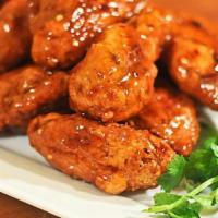 Thai Chili Wings · Crispy chicken wings tossed in spicy Thai chili sauce and lots of garlic. Served with kim ch...