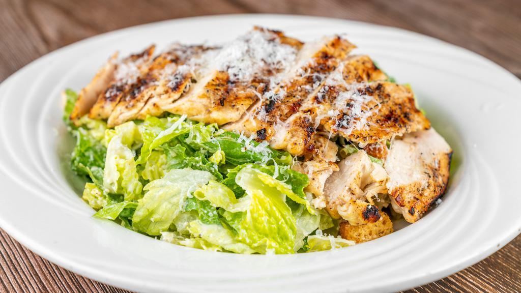 Caesar Salad With Grilled Chicken · Romaine lettuce with grilled chicken in a creamy Caesar dressing with shaved parmesan cheese and croutons.