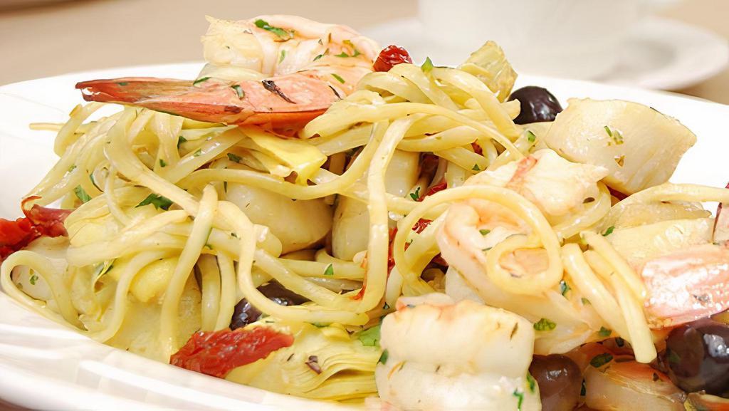 Shrimp Cariofo · Shrimp sautéed with hearts of artichokes and sun dried tomatoes drizzled with extra virgin olive oil over capellini pasta.