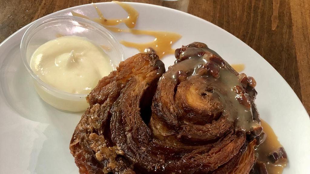 The B-Roll · Biscuit Cinnamon Roll made with our Signature Buttermilk Biscuit Dough, Served with Pecan Sticky Bun Sauce and Cream Cheese Icing