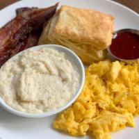 Egg Plate · Two Eggs Any Style, Cheese Grits, Buttermilk Biscuit, Jam, Choice of Bacon or Sausage.