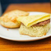 E.C. · Buttermilk Biscuit Topped with Smoked Sausage, One Scrambled Egg and Aged Cheddar. Add Sausa...