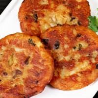 Aloo-Tikki · 2 Pieces of spicy fried potato patty served with our special sauces