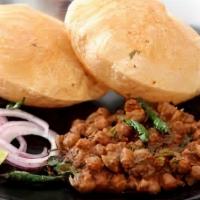 Puri Cholay · two deep fried wheat bread served with chickpeas and pickles