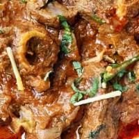 Goat Karahi · Prepared in a reduced tomato based sauce with fresh cilantro jalapeno and ginger